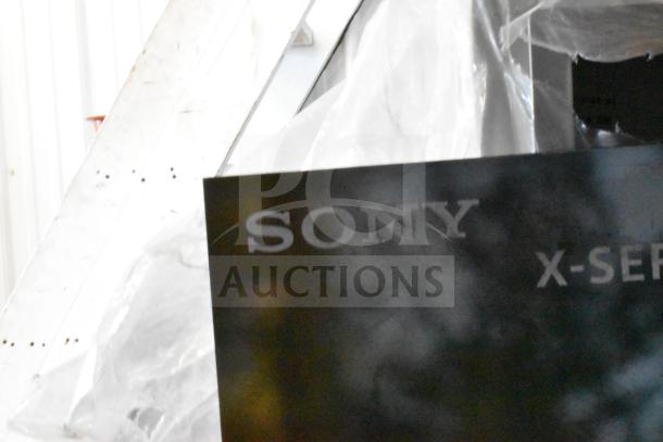 Sony store display with speakers, featuring "Sony X-Series" logo. Appears in good condition, ideal for promotional use.