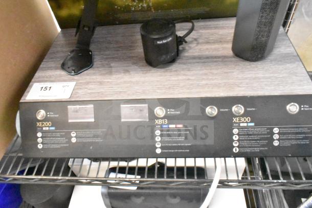 Sony store display with XE200, XB13, and XE300 speakers. Features volume controls and labels. Good condition.