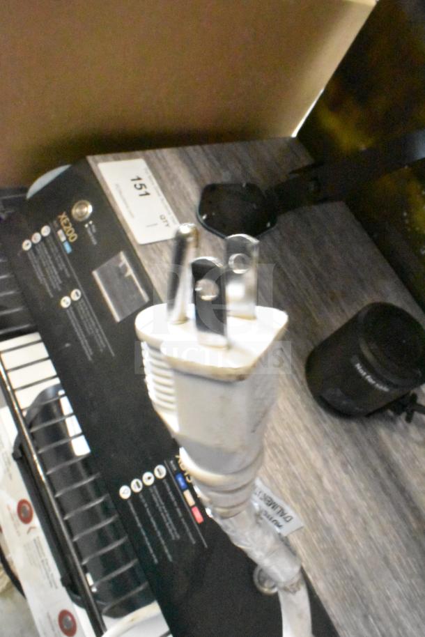 Sony store display with speakers, featuring partially visible control panel and power plug, labeled "Sony."