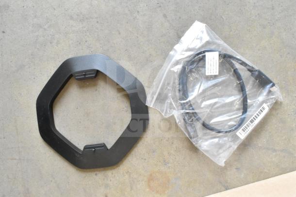 HP Thin Client accessories including a black hexagonal stand and a cable in sealed packaging, both in new condition.