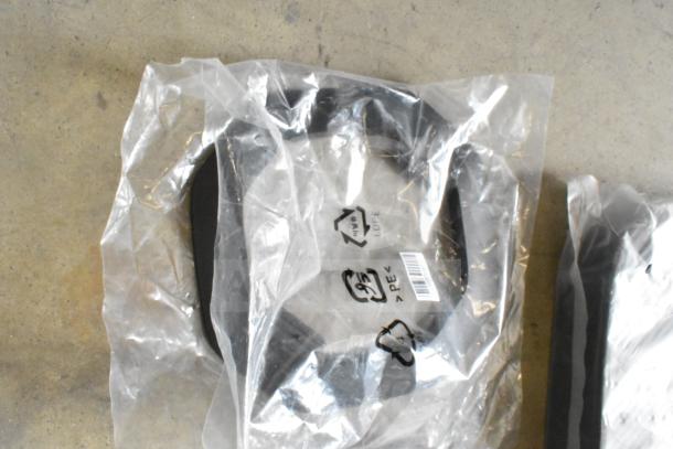 Plastic-wrapped lot of miscellaneous items including cables, visible recycling symbols, and barcodes on packaging.