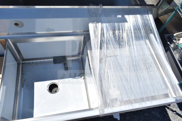 BRAND NEW Regency 600S3242424C L-shaped 3 bay sink with dual drain boards, no legs, in scratch and dent condition.