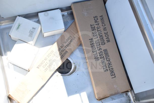 BRAND NEW scratched Regency 600S3242424C L-shaped 3 bay sink with dual drain boards, no legs, boxed components visible.