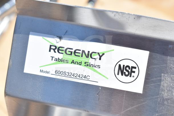 Brand new Regency 600S3242424C L-shaped sink, scratch and dent, dual drain boards, no legs, NSF certified label visible.