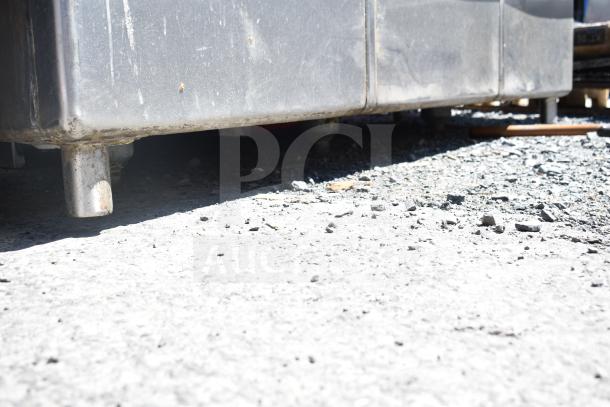 TSB-3-R2 commercial 3 bay sink with right side drain boards, no legs, stainless steel, showing wear and dirt at the base.