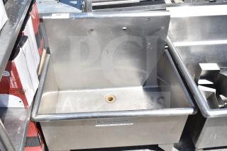 Stainless steel commercial single bay sink, missing legs, with "No Handwashing" label. Visible drain opening. Good condition.