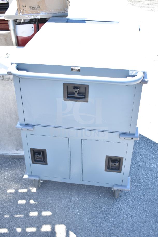 Gray metal unit with 3 compartments on commercial casters, features secure handles and a rugged design for versatile use.
