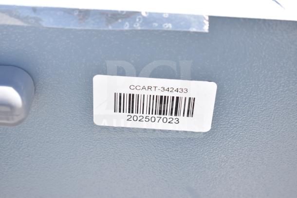 Gray metal unit with 3 compartments on commercial casters, label reads "CCART-342433" and barcode "202507023".