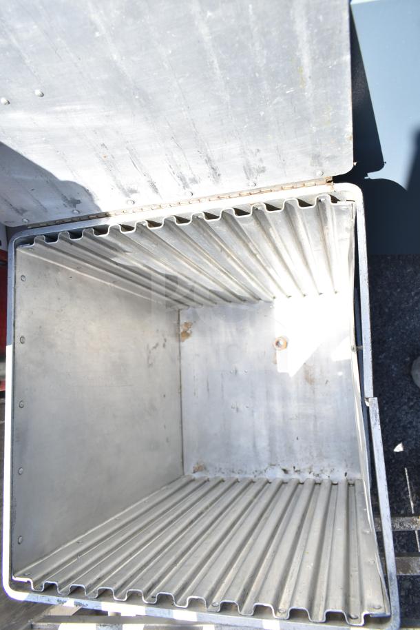 CresCor metal catering case with corrugated interior, open lid, and visible rivets. Signs of wear, suitable for food transport.