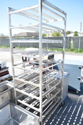 Commercial #10 can rack with multiple shelves, made of metal on heavy-duty casters for mobility, good condition.