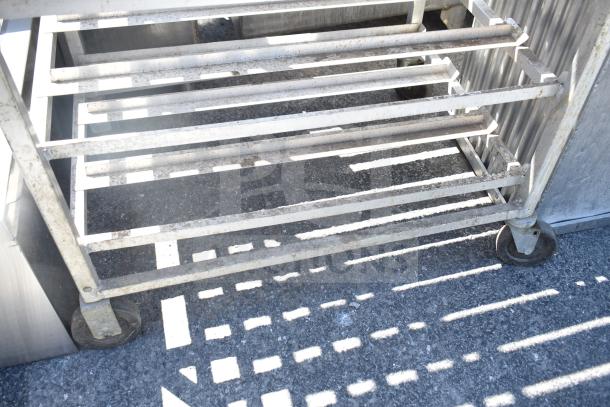 Commercial #10 can rack on casters, metal, worn condition, rust visible, sturdy structure, suitable for kitchen use.