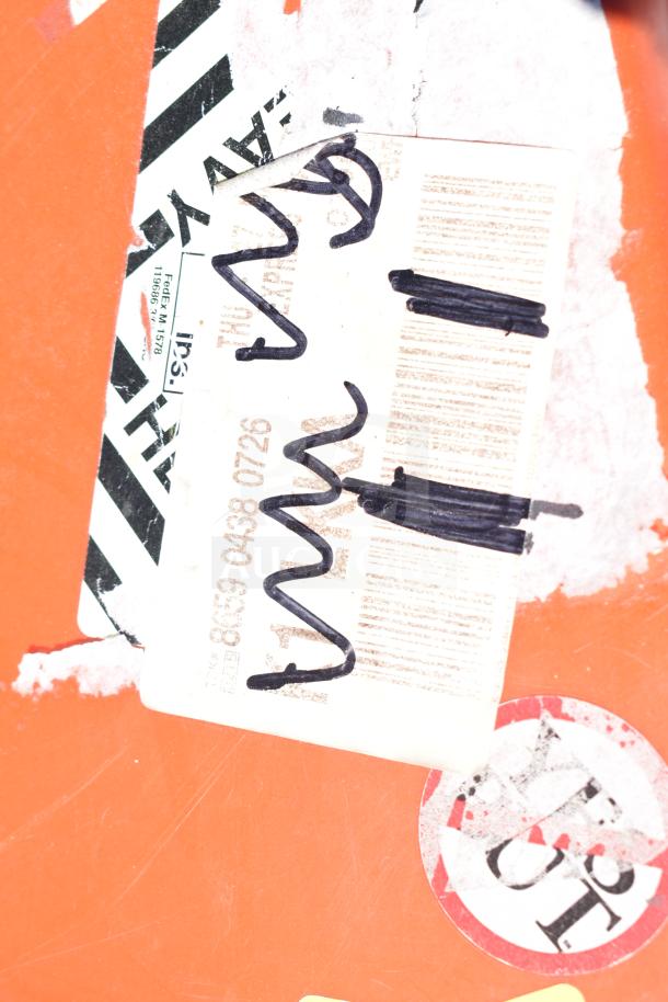 Orange case with visible shipping labels and handwritten markings. Case shows signs of wear, indicating prior use.