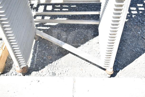 Two metal pans on commercial casters, sturdy construction, minor wear, suitable for industrial use, multiply bid by two.