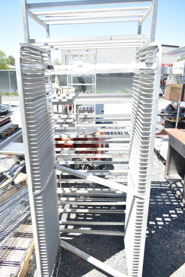 Two commercial metal pan racks on casters, ideal for kitchen use. Sturdy metal construction. Lot tag indicates double bid offer.