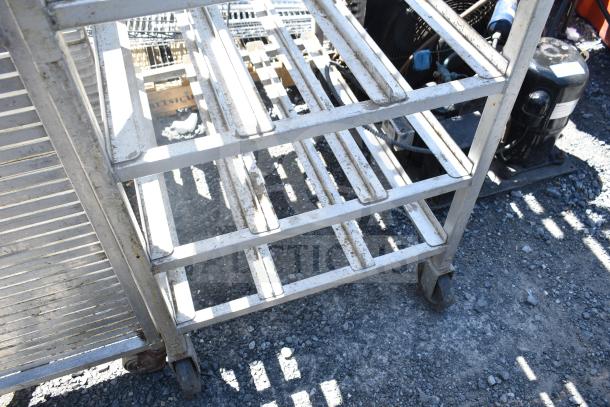 Two metal pans on commercial casters, sturdy metal frames, visible wear, ideal for industrial use, bid multiplies by two.