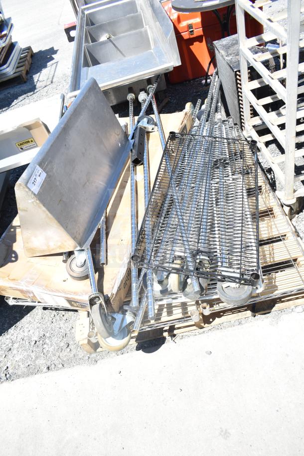 Wire shelf with metal poles and wall mount shelf on pallet; includes caster wheels. Good condition, ideal for storage solutions.