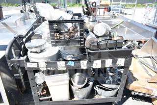 Black poly 2-tier cart with skillets, poly bins, and various kitchen items. Used condition with visible labels and contents.