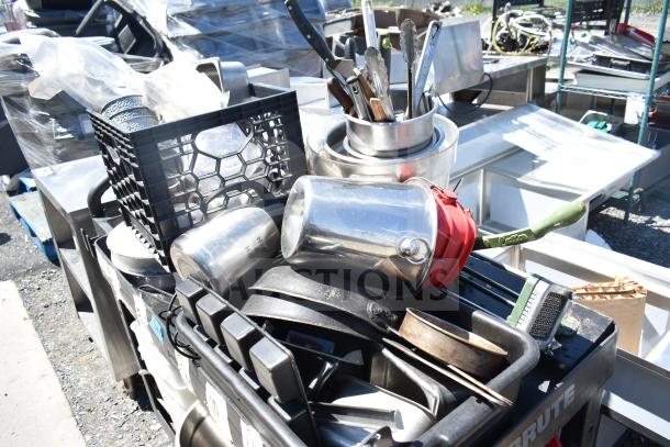 Black poly 2-tier cart with assorted contents, including skillets and poly bins, various kitchen utensils, in used condition.