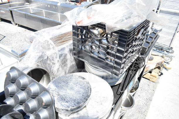 Black poly 2-tier cart with assorted contents including skillets, poly bins, and kitchenware, in good condition.