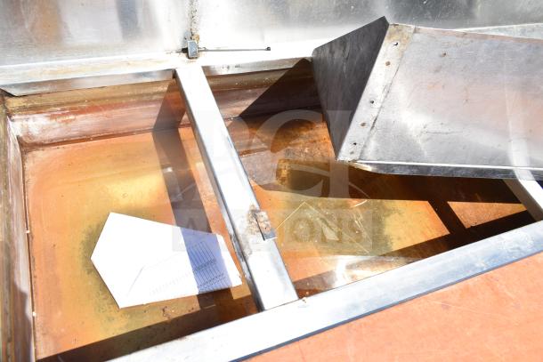 Commercial steam table with under shelf, metal construction, visible rust and wear, includes drainage basin.