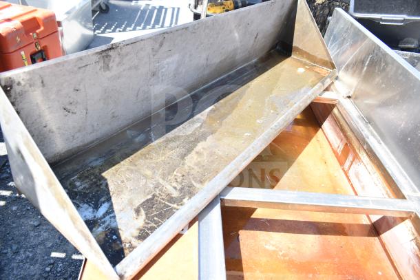 Commercial steam table with under shelf in used condition, features stainless steel construction and visible wear.