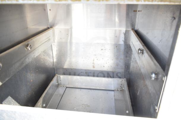 Commercial steam table with under shelf, stainless steel construction, interior view showing moderate wear and sturdy design.