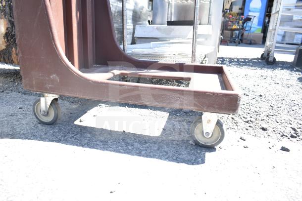 Brown poly dish caddy dolly with commercial casters, showing moderate wear. Ideal for transporting dishware efficiently.
