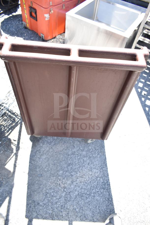 Brown poly dish caddy dolly on commercial casters, labeled "Cambro," with two compartments, used condition.