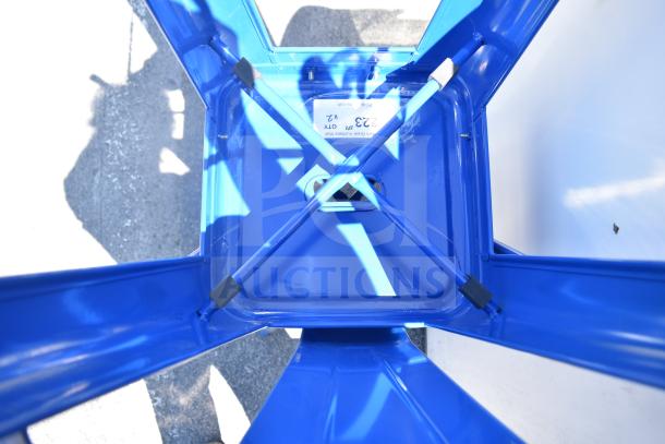 2 blue finish Tolix style bar height chairs, metal frame, under-seat view showing cross-bracing and label indicating quantity.
