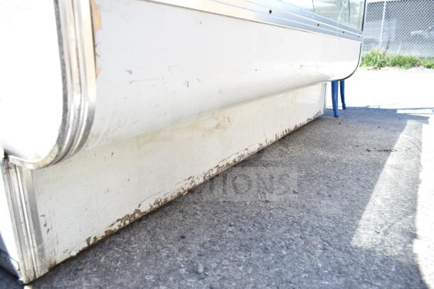 Leader MCB77 Deli Display Case, commercial floor style. Visible wear on exterior, 115 Volts, 1 Phase.