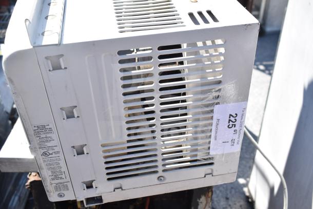 Frigidaire FAX052P7A window air conditioner, 115 volts, 1 phase. Side view shows label with model and voltage details.