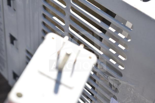 Frigidaire FAX052P7A window air conditioner close-up. 115 volts, detailed view of rear grille and power plug.