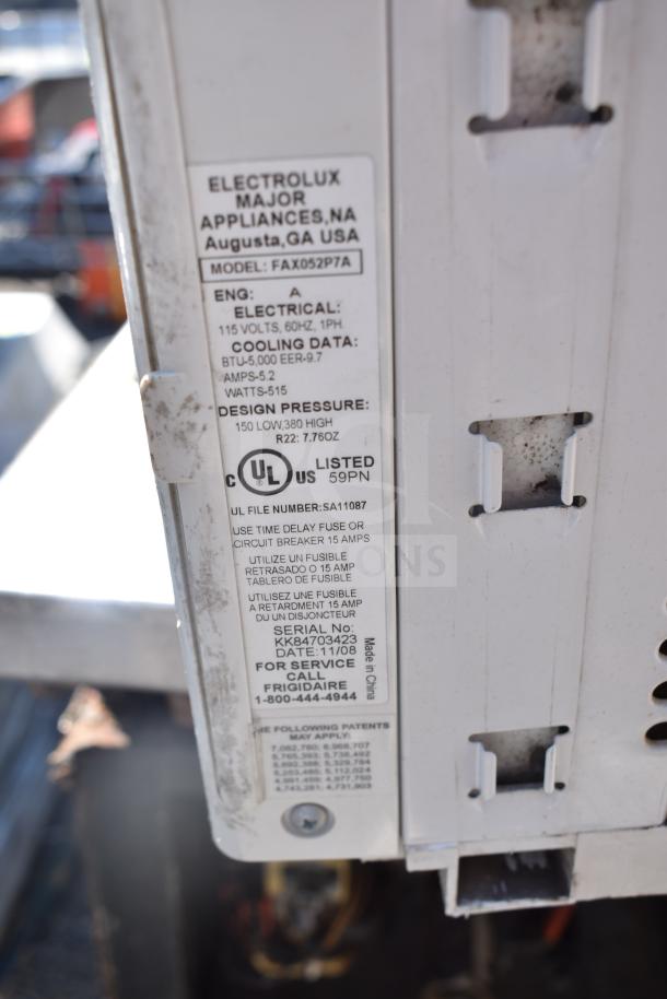 Frigidaire FAX052P7A window air conditioner label showing model, 115 volts, and specs like BTU 5,000 and EER 9.7.