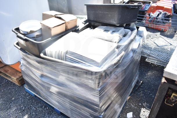 Pallet lot with square plates, bowls, and assorted items wrapped in plastic, various conditions, ready for auction.