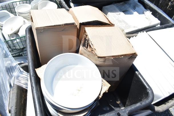Pallet lot with stacked white bowls, square plates, and various items in cardboard boxes. Items appear gently used.