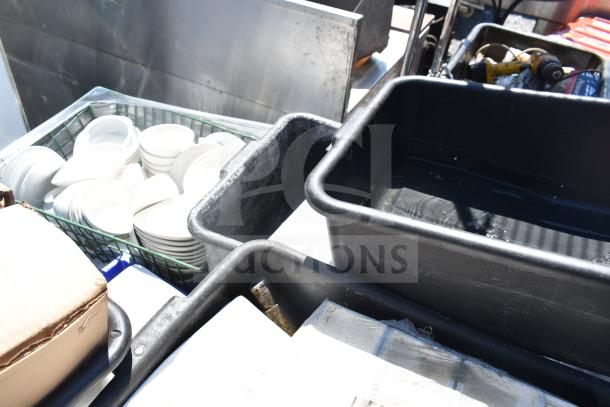 Pallet of assorted items including white square plates and bowls in crates. Visible black tubs and cardboard boxes. Mixed condition.
