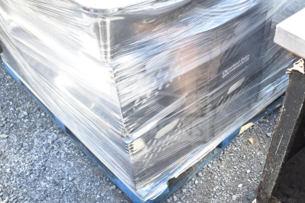 Pallet of various items wrapped in plastic, including square plates and bowls, visible box labeled "Cloverland Dairy."