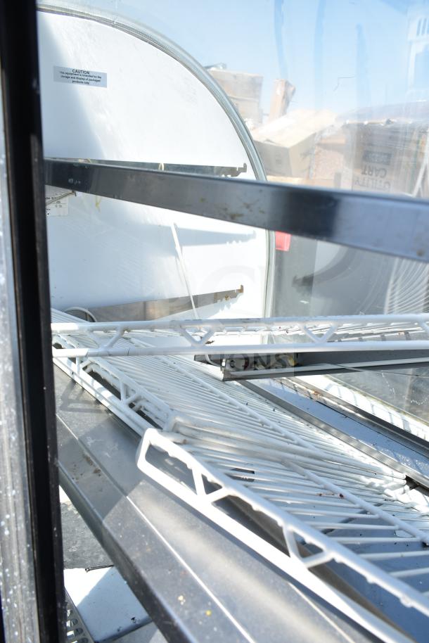 Leader CVK48 S/C deli display case, metal shelves, minor wear, caution label visible, 115V, 1 phase.