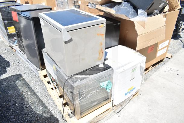 Four mini coolers by Frigidaire, Arctic Air, and Accucold. Visible wear. 115 volts, 1 phase. Stored on pallets.