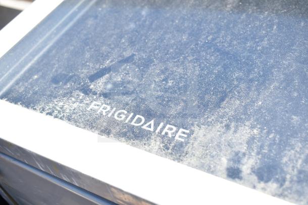 Four mini coolers including Frigidaire, Arctic Air, Accucold; 115 volts, 1 phase. Dust-covered Frigidaire logo visible.