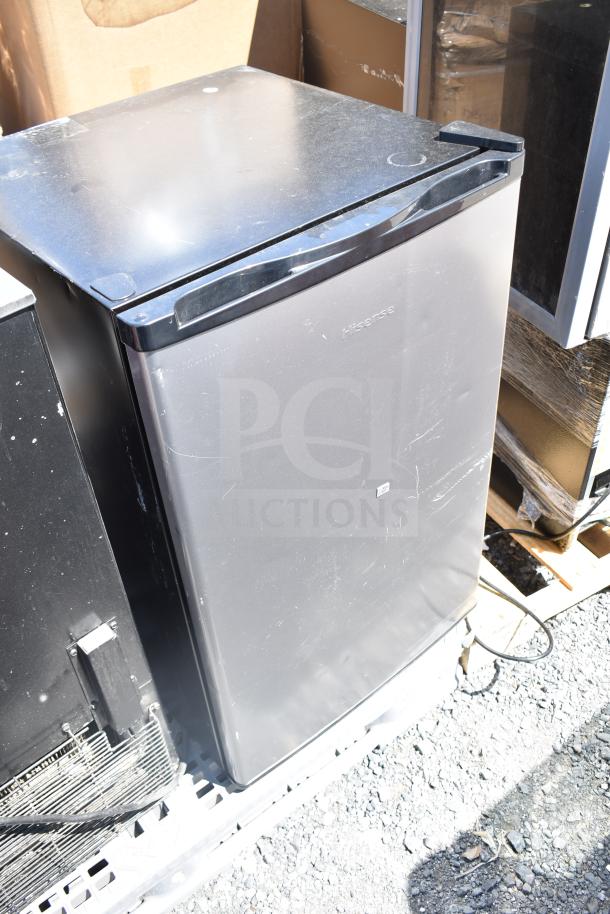 Silver Hisense mini cooler on a pallet, 115 volts, 1 phase, minor surface wear, suitable for compact spaces.