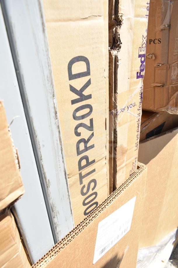 14 brand new scratch and dent items in boxes, including wall corner guard, work table, dolly. Visible labels and markings.