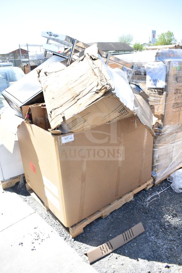Cardboard boxes on pallets containing 16 scratch and dent items, including trash cans and ingredient bins. Item number 237 visible.