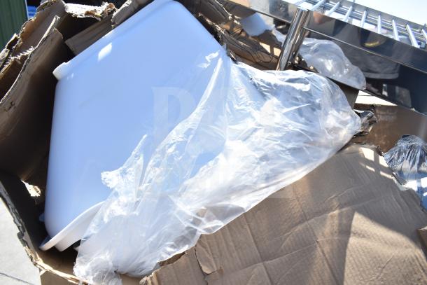 "Assorted scratch and dent items including white trash can and metal ingredient bins in damaged packaging."