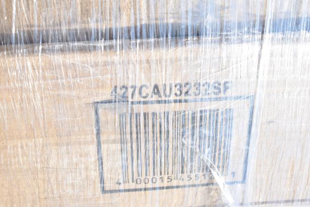Cardboard box wrapped in plastic with label "427CAU3232SF" and a barcode, containing 12 new scratch and dent items.