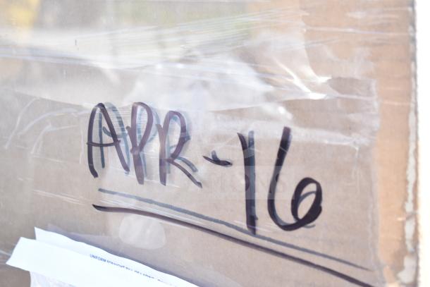 Cardboard packaging labeled "APR-16," containing 12 new scratch and dent items, including a dunnage rack and shelf kit.