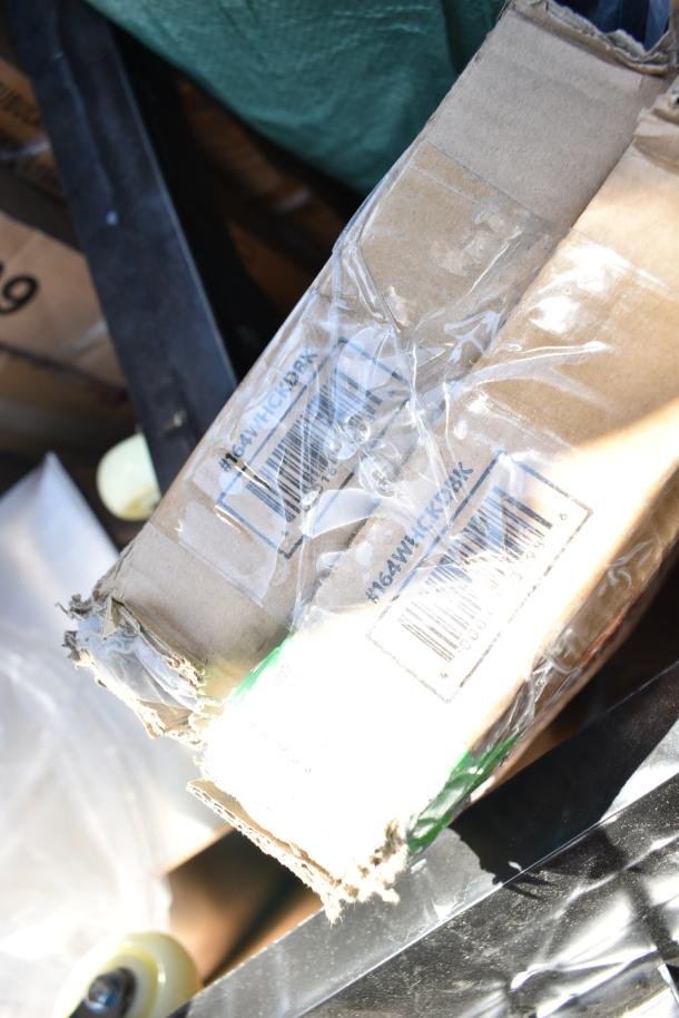 Damaged box labeled "164WHCKD9K" with visible barcode, part of a lot of 12 scratch and dent items including a high chair, shelves, and trash cans.