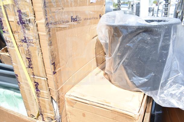 Boxes labeled "FedEx" containing brand new scratch and dent items, including a trash can wrapped in plastic.