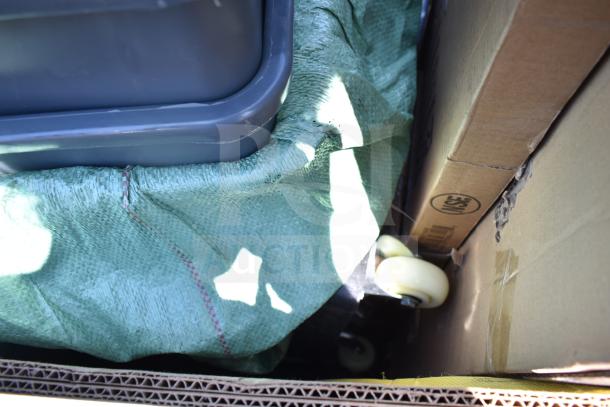 12 scratch and dent items including a high chair, wall shelves, and trash cans. Brand new; details visible in packaging.