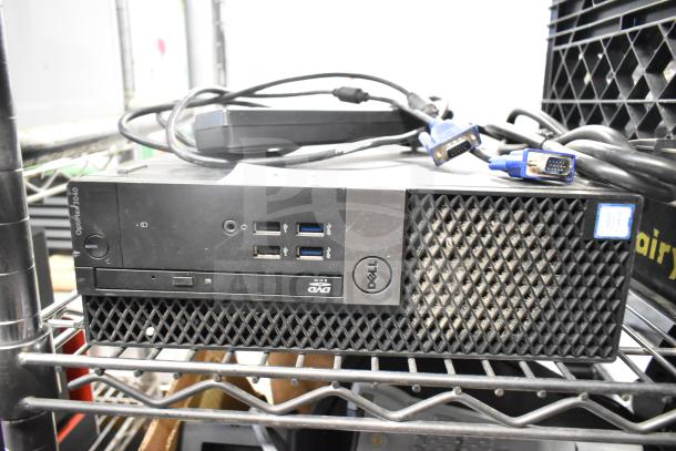 Dell OptiPlex 3040 computer tower, front ports visible; features Intel Core sticker. Includes power cables; in used condition.
